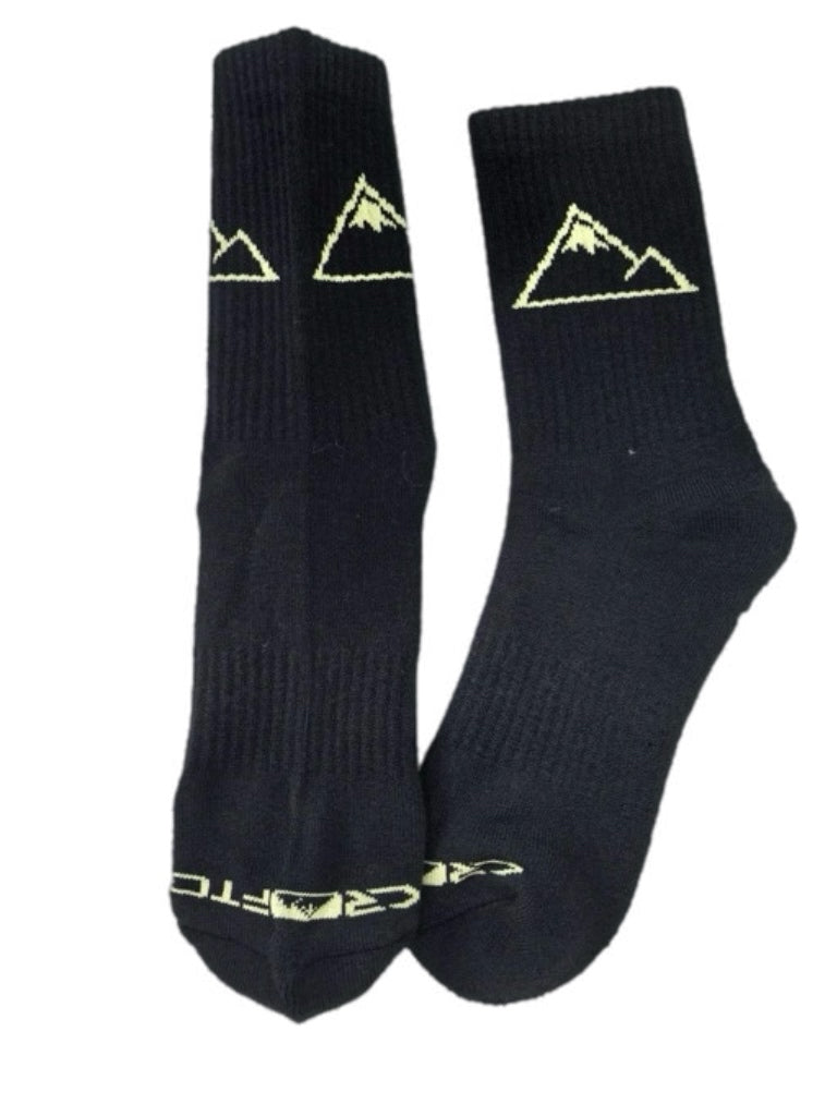 A pair of black Crofto MTB crew socks with a gold embroidered mountain logo and the brand name 'CROFTO' on the toe area, shown against a plain white background.