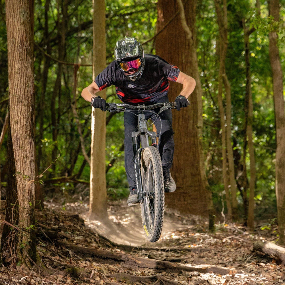 Person riding a mountain bike on a trail in a forest