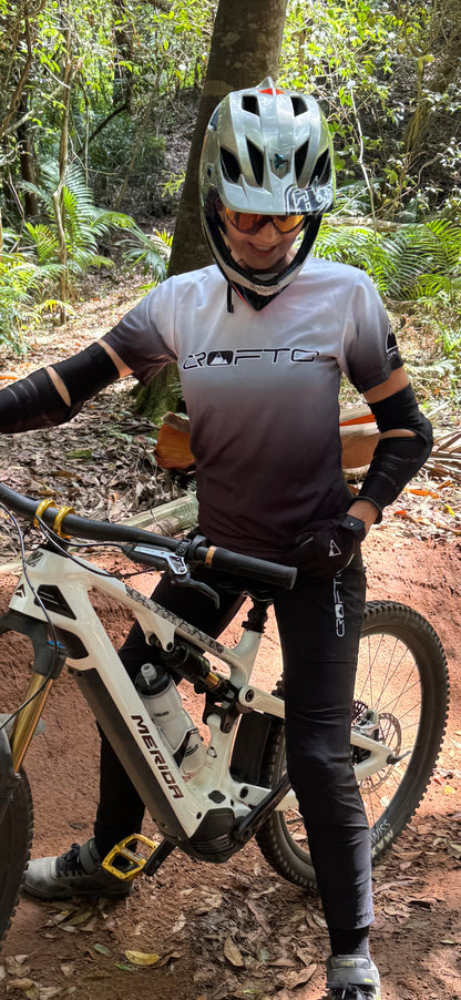 Person with a mountain bike in a forest setting