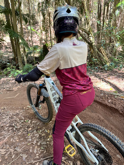 Rear view of CROFTO Women's Amaroo Lite maroon MTB pants showing the tapered riding fit, black panels and gold CROFTO branding.