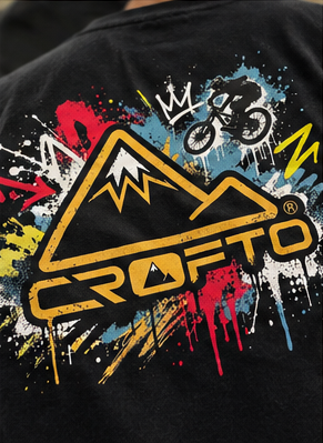 Close-up of CROFTO Paintstorm Tee rear graphic featuring mountain illustration, paint splatter design and CROFTO branding