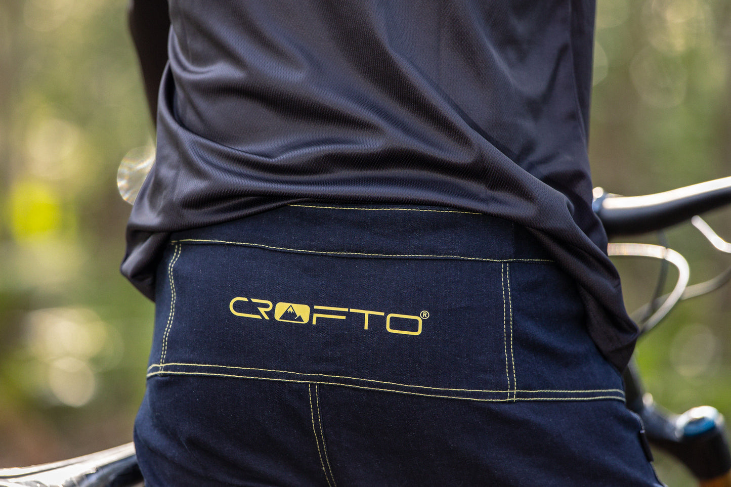 Close up of the back waistband of CROFTO Denim MTB Jorts showing navy shorts with gold CROFTO logo and stitching
