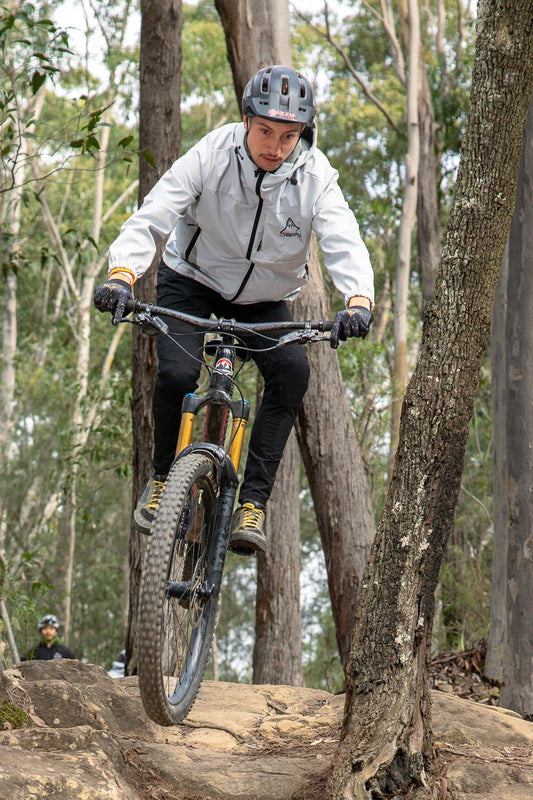 MTB rider wearing CROFTO soft shell MTB jacket in forest trail Australia 