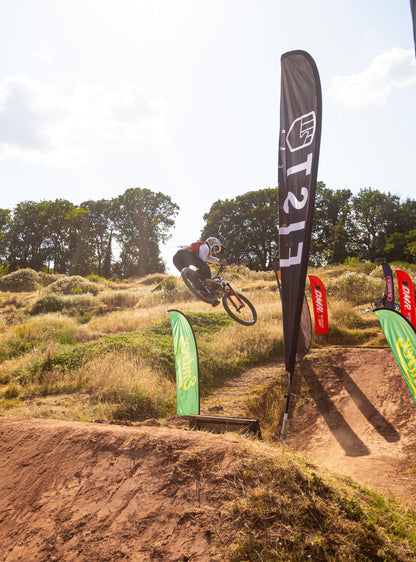 A mountain biker wearing crofto Jekyl jersey and Amaroo pants doing a jump at dirtwars competition 