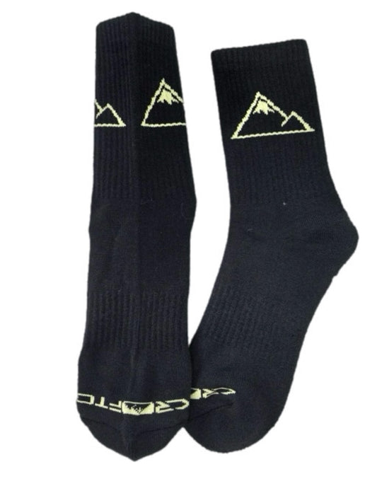 A pair of black Crofto MTB crew socks with a gold embroidered mountain logo and the brand name 'CROFTO' on the toe area, shown against a plain white background.