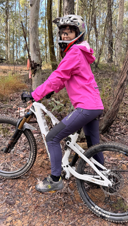 Woman riding a mountain bike in forest in crofto amaroo pants
