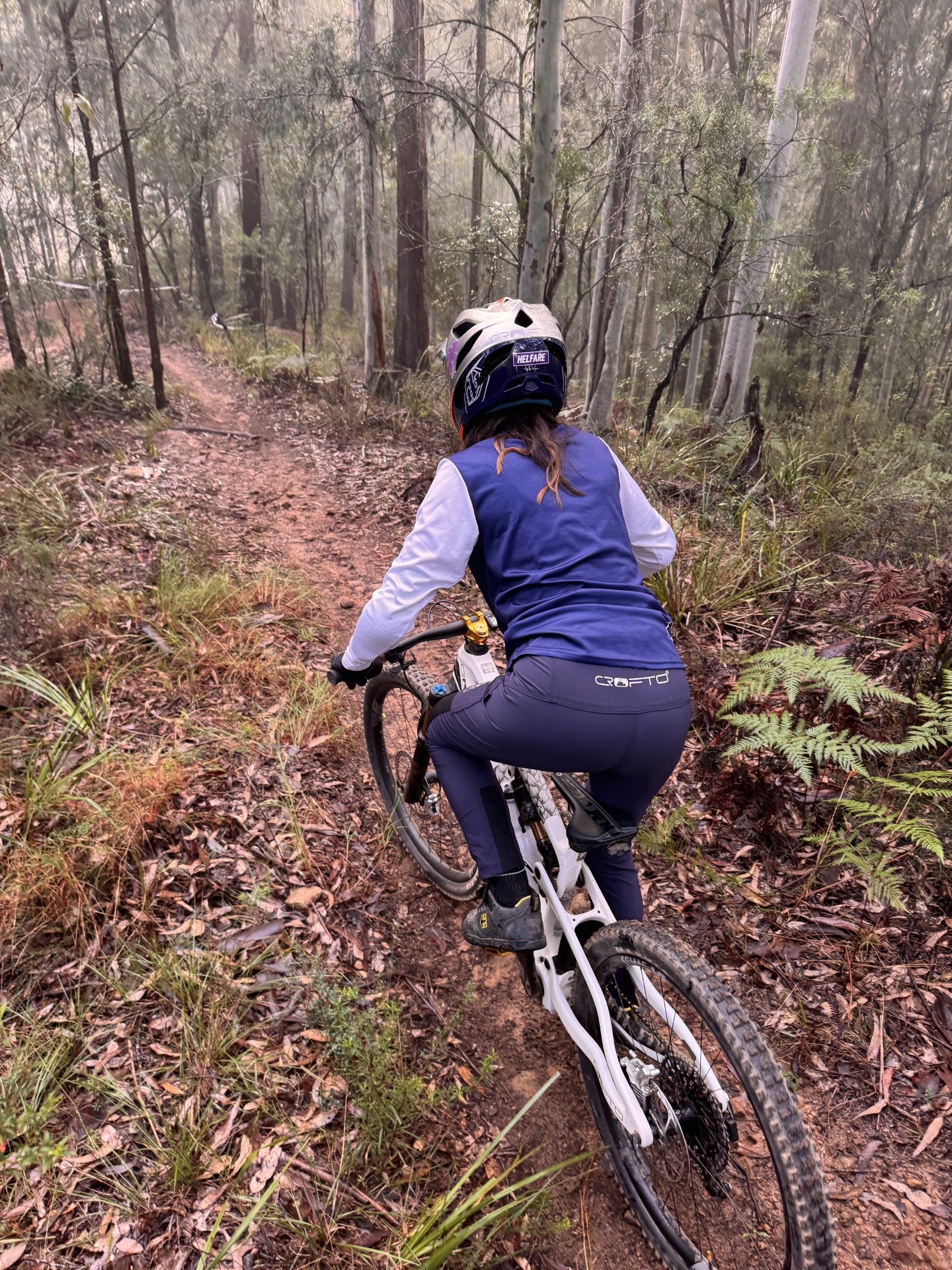 Woman riding a mountain bike in forest in crofto amaroo pants