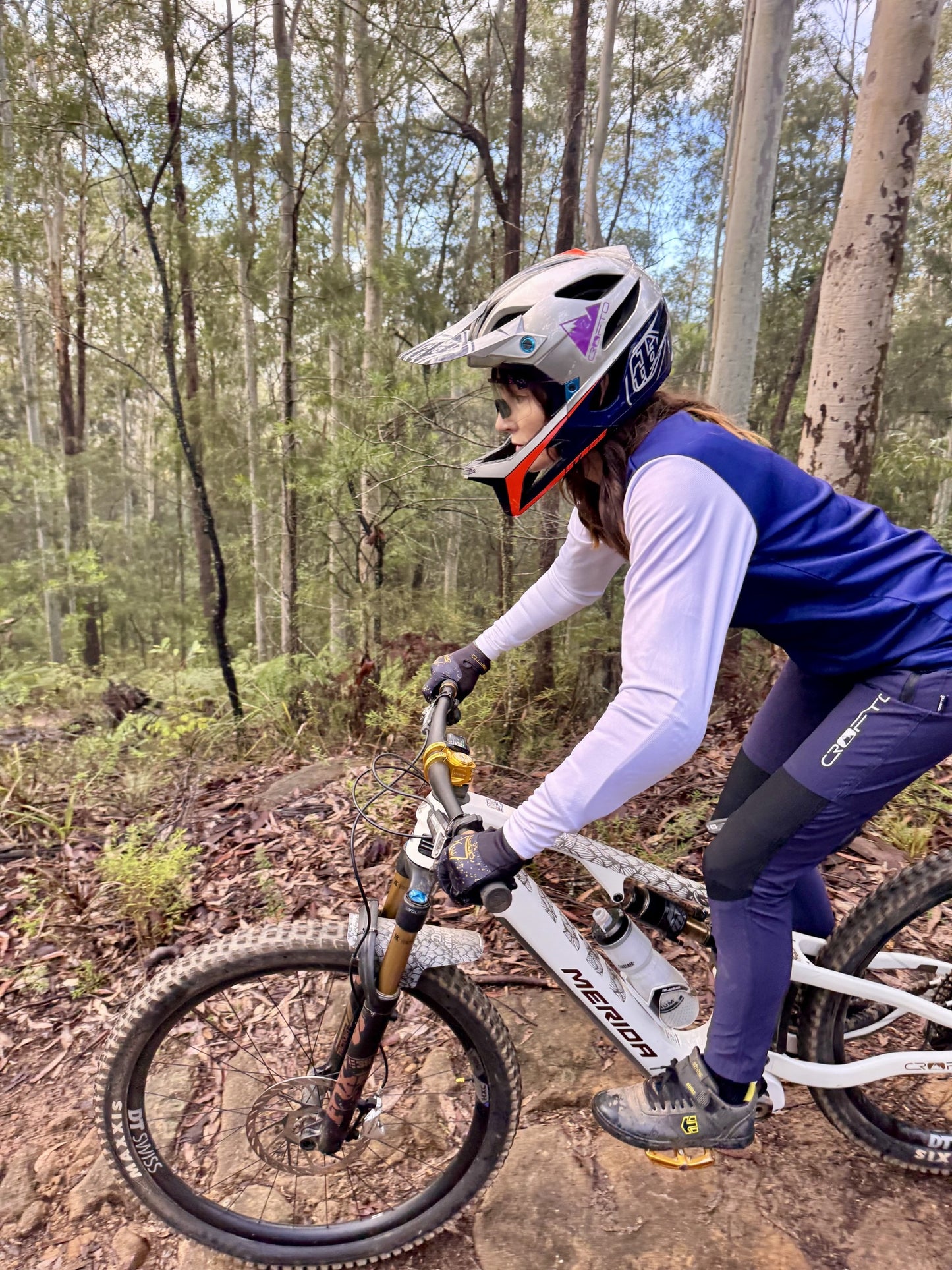 Woman riding a mountain bike in forest in crofto amaroo pants