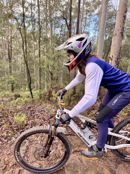 Woman riding a mountain bike in forest in crofto amaroo pants