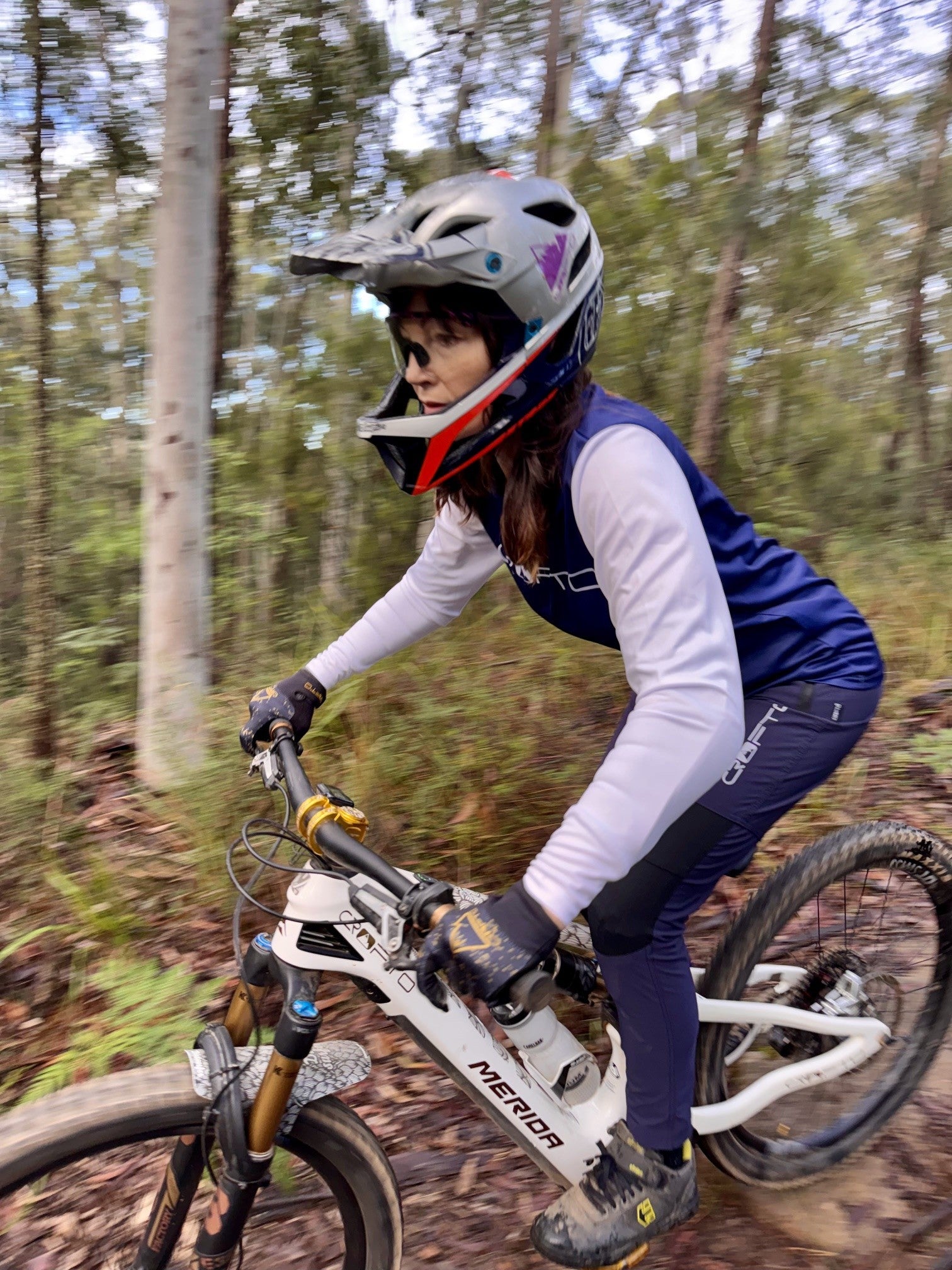Woman riding a mountain bike in forest in crofto amaroo pants