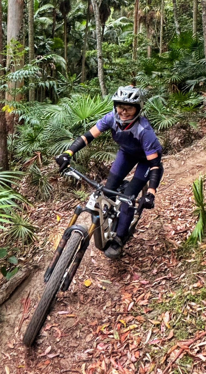 Person riding a mountain bike on a trail in a forest