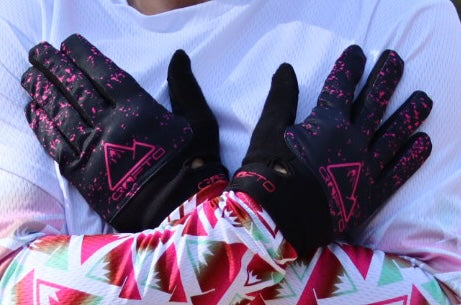A close up of man wearing a pair of CROFTO Apex pro mountain bike gloves in hot pink and black  