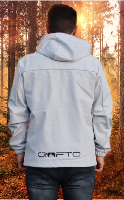 Person wearing a light gray jacket with 'Crofto' branding in a forest setting